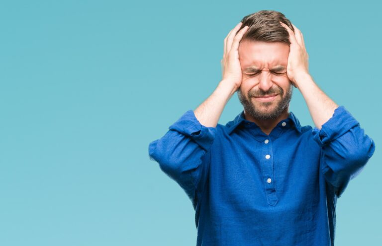 Man in Lewis Center holding head in his hands while wearing a blue shirt