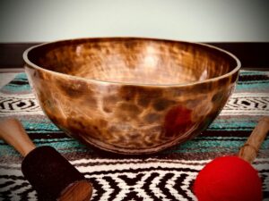 A Tibetan singing bowl with mallets on either side