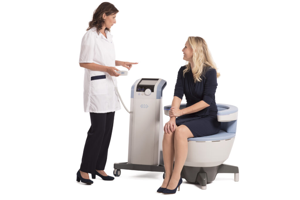 A woman sitting in the BTL Emsella chair and consulting with a medical provider