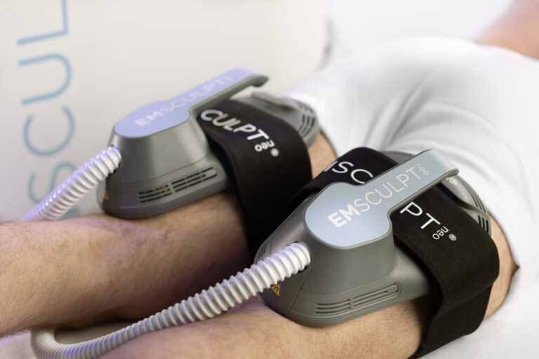Emsculpt Neo being applied to the back of a male patient's thighs