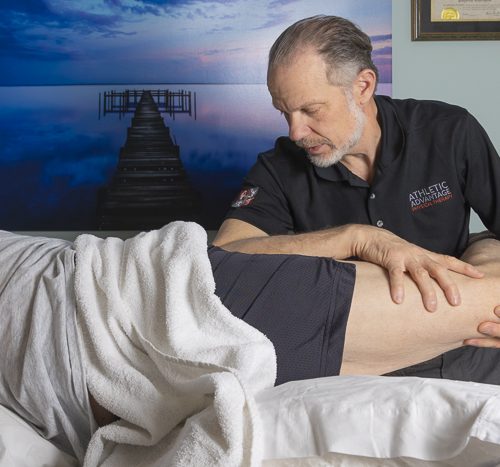 Mark Read perfoms myofascial release therapy on patient's leg