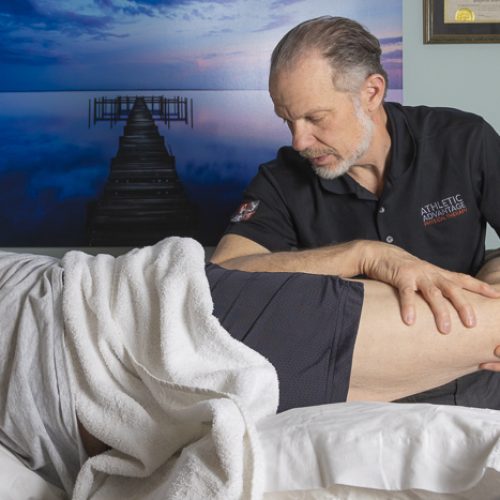 Mark Read perfoms myofascial release therapy on patient's leg